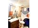 Well-lit bathroom with a modern vanity, decorative mirror, and stylish shower curtain for a fresh feel at 6328 Newtown Cir # 28A1, Tampa, FL 33615