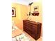 Bedroom with a light pink wall, wooden dresser, and decorative decor at 6328 Newtown Cir # 28A1, Tampa, FL 33615