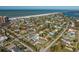 Aerial view of community, showcasing mature trees and proximity to the beach at 66 Kipling Plz, Clearwater Beach, FL 33767