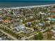 High angle shot of a waterfront neighborhood featuring colorful homes, tall trees and sandy beaches at 66 Kipling Plz, Clearwater Beach, FL 33767