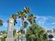 Clearwater Beach sign with palm trees overlooking a marina and city buildings at 66 Kipling Plz, Clearwater Beach, FL 33767