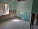 Bedroom in renovation with bare walls and stone tile floors, bathed in natural light from the window at 66 Kipling Plz, Clearwater Beach, FL 33767