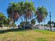 North Beach residential neighborhood sign surrounded by lush palm trees and greenery at 66 Kipling Plz, Clearwater Beach, FL 33767