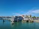 Picturesque marina view featuring docked boats, waterfront dining, and city skyline at 66 Kipling Plz, Clearwater Beach, FL 33767