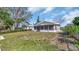 Home's backyard with a green lawn and a view of a screened-in porch at 7048 68Th N St, Pinellas Park, FL 33781