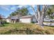 Charming single Gathering house with a long driveway and well-maintained landscaping on a sunny day at 7048 68Th N St, Pinellas Park, FL 33781