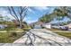 Charming single Gathering house with a long driveway and well-maintained landscaping on a sunny day at 7048 68Th N St, Pinellas Park, FL 33781