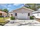 A detached single-car garage with a concrete driveway and tidy landscaping on a sunny day at 7048 68Th N St, Pinellas Park, FL 33781