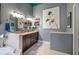 Bathroom featuring a soaking tub, dual sink vanity, framed mirrors, and granite countertops at 707 Highland N St, St Petersburg, FL 33701