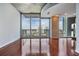 Bright living area with hardwood floors and a wall of windows offering stunning city views at 777 N Ashley Dr # 1505, Tampa, FL 33602