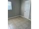 Bedroom featuring tiled floors, neutral walls, and natural light at 7908 Rideout Rd, Tampa, FL 33619