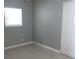 Neutral bedroom with tile flooring, closet and window at 7908 Rideout Rd, Tampa, FL 33619