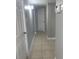 Hallway with tiled flooring and neutral color palette at 7908 Rideout Rd, Tampa, FL 33619