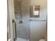 Updated bathroom features a tiled shower, grab bar, and neutral color palette at 8969 109Th Ter, Seminole, FL 33777