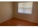 An empty bedroom with wood floors and a bright window at 8969 109Th Ter, Seminole, FL 33777