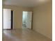 Neutral bedroom featuring tile flooring, and view of the attached en-suite bathroom at 8969 109Th Ter, Seminole, FL 33777