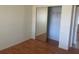 A bedroom with wood floors and a closet with sliding mirror doors at 8969 109Th Ter, Seminole, FL 33777