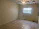 Clean, neutral bedroom featuring tile flooring, ceiling fan, and natural light from one window at 8969 109Th Ter, Seminole, FL 33777