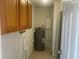 Utility Room with cabinets, water heater, and concrete block walls at 8969 109Th Ter, Seminole, FL 33777