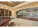 Elegant lobby area featuring decorative ceiling, grand piano, plants and tiled floors at 918 Regal Manor Way, Sun City Center, FL 33573