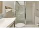 Bright bathroom featuring a vanity, toilet, and shower with sliding glass door at 9920 Indian Key Trl # 29, Seminole, FL 33776