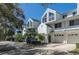 A row of white townhouses with garages, green roofs, and nice manicured front yards at 9920 Indian Key Trl # 29, Seminole, FL 33776