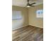 Bedroom with a ceiling fan, window with blinds and wood floors at 9346 52Nd Way, Pinellas Park, FL 33782