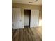 Bedroom with closet, light colored walls and new wood floors at 9346 52Nd Way, Pinellas Park, FL 33782