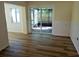 Open dining room with sliding door to screened lanai and new wood floors at 9346 52Nd Way, Pinellas Park, FL 33782