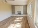 Bright and airy living room featuring a striking fireplace, modern flooring, and plenty of natural light through large windows at 9346 52Nd Way, Pinellas Park, FL 33782