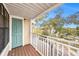 Balcony view showcasing a teal door, wood deck, and white railing at 1000 W Horatio St # 327, Tampa, FL 33606