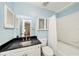 Bathroom with blue walls, tile, and black granite sink at 1000 W Horatio St # 327, Tampa, FL 33606