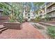 Beautiful courtyard with brick pavers, lush landscaping, and multi-story condo building in the background at 1000 W Horatio St # 327, Tampa, FL 33606