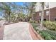 Brick driveway with mature trees and lush landscaping that compliments the exterior brick facade at 1000 W Horatio St # 327, Tampa, FL 33606