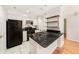 Kitchen with granite countertop island, white cabinets, and modern appliances at 1000 W Horatio St # 327, Tampa, FL 33606