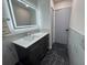 Bathroom featuring new marble floors, vanity with gray cabinet, and modern mirror at 11485 Oakhurst Rd # 1200-2, Largo, FL 33774