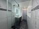 Bathroom featuring new marble floors, glass shower, and modern fixtures at 11485 Oakhurst Rd # 1200-2, Largo, FL 33774