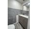 Bathroom featuring vanity with gray cabinet, modern countertop and gray tile at 11485 Oakhurst Rd # 1200-2, Largo, FL 33774