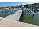 The picture showcases a private boat dock with a boat lift at 12155 5Th E St, Treasure Island, FL 33706