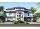 A two-story home with a black roof, two-car garage, and manicured landscaping at 12155 5Th E St, Treasure Island, FL 33706