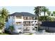 A view from the back of a modern home with a pool and outdoor seating area at 12155 5Th E St, Treasure Island, FL 33706