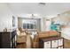 Cozy living room with hardwood floors, large windows, and a stylish ceiling fan at 12402 Country White Cir, Tampa, FL 33635