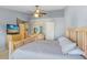 Neutral-toned main bedroom providing an inviting atmosphere with lots of natural light and ceiling fan at 12402 Country White Cir, Tampa, FL 33635