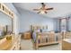 Comfortable main bedroom with soft blue walls, matching furniture, and a ceiling fan at 12402 Country White Cir, Tampa, FL 33635