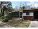 Backyard view of the house with screened in porch at 13924 Morgan St, Dade City, FL 33525