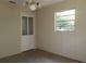 Neutral bedroom featuring a closet and a window at 13924 Morgan St, Dade City, FL 33525