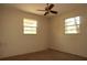 Cozy bedroom with two windows and neutral colored walls at 13924 Morgan St, Dade City, FL 33525