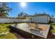 Inviting backyard deck with grill and outdoor seating perfect for entertaining, with a sun-drenched lawn and landscaping at 1409 W Wood St, Tampa, FL 33604