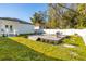 Expansive backyard deck with a grill offers a great outdoor space, set within a lush yard, and a white privacy fence at 1409 W Wood St, Tampa, FL 33604