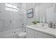 Elegant bathroom featuring a glass-enclosed shower, a soaking tub, marble-look tile and modern fixtures at 1409 W Wood St, Tampa, FL 33604